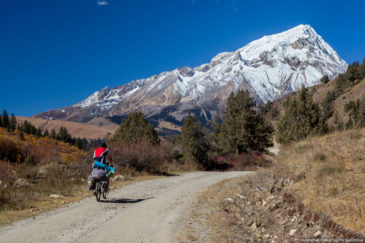 Traveller cycling in mountains