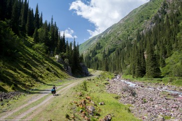 Cyclist on abandoned road in Tien Shan Mountains