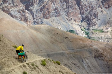 Cycling tourist on narrow path. Zanskar, Himalaya mountains