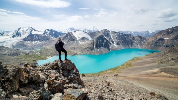 Hiker looking at Ala-Kul lake in Tien Shan mountains, Kyrgyzstan