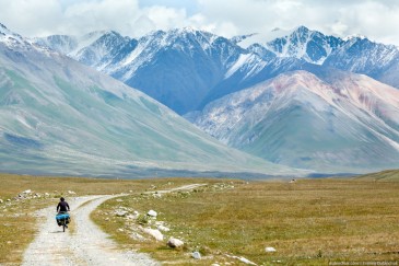 Travelling cyclist in Tien Shan Mountains. Kirghizia