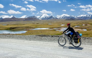 Girl cycling in Tien Shan Mountains