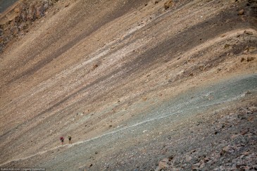 Hikers going to the pass by trail in Tien Shan Mountains. Kyrgyzstan
