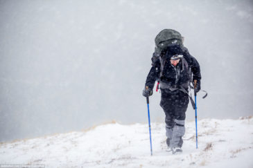 Hiker in severe weather conditions. Altai mountains