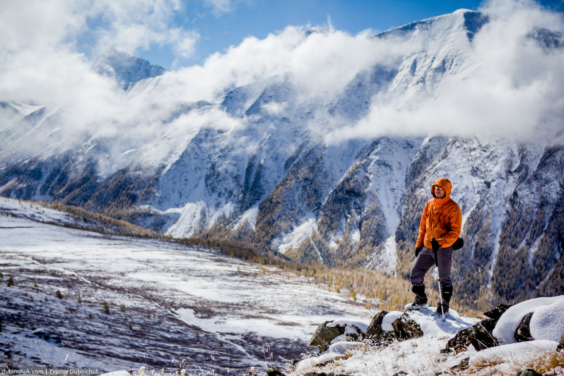 Hiker on the top of the pass in mountains of Altai