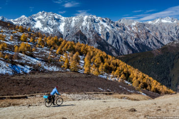 Adventure cyclist in Tibet mountains in autumn